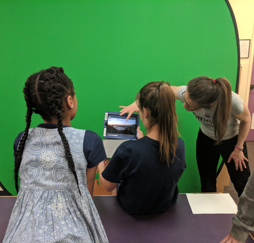 girls learning to make green screen special effects with an iPad